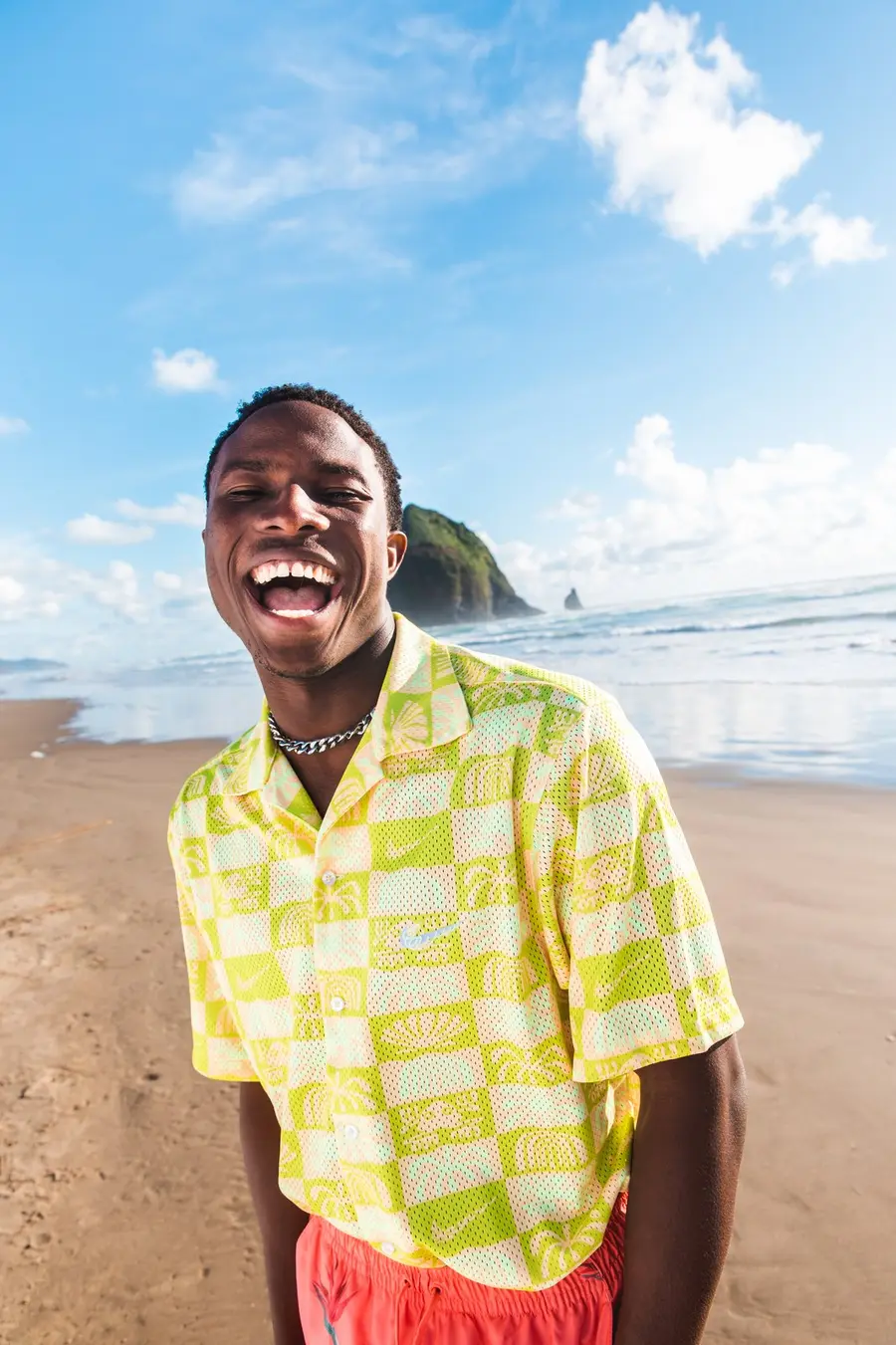 A man laughing on the beach for Nike