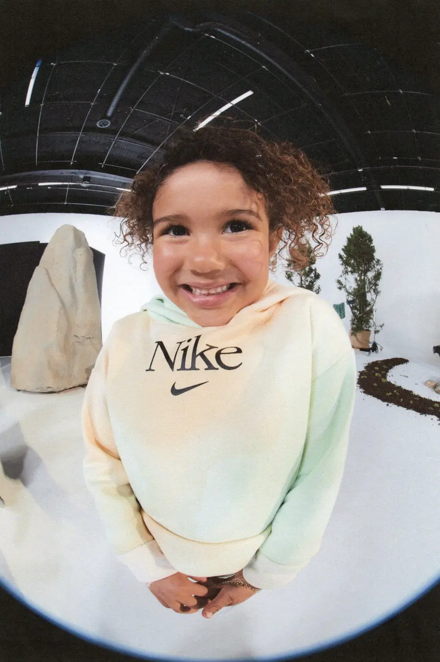 A kid in a Nike hoodie