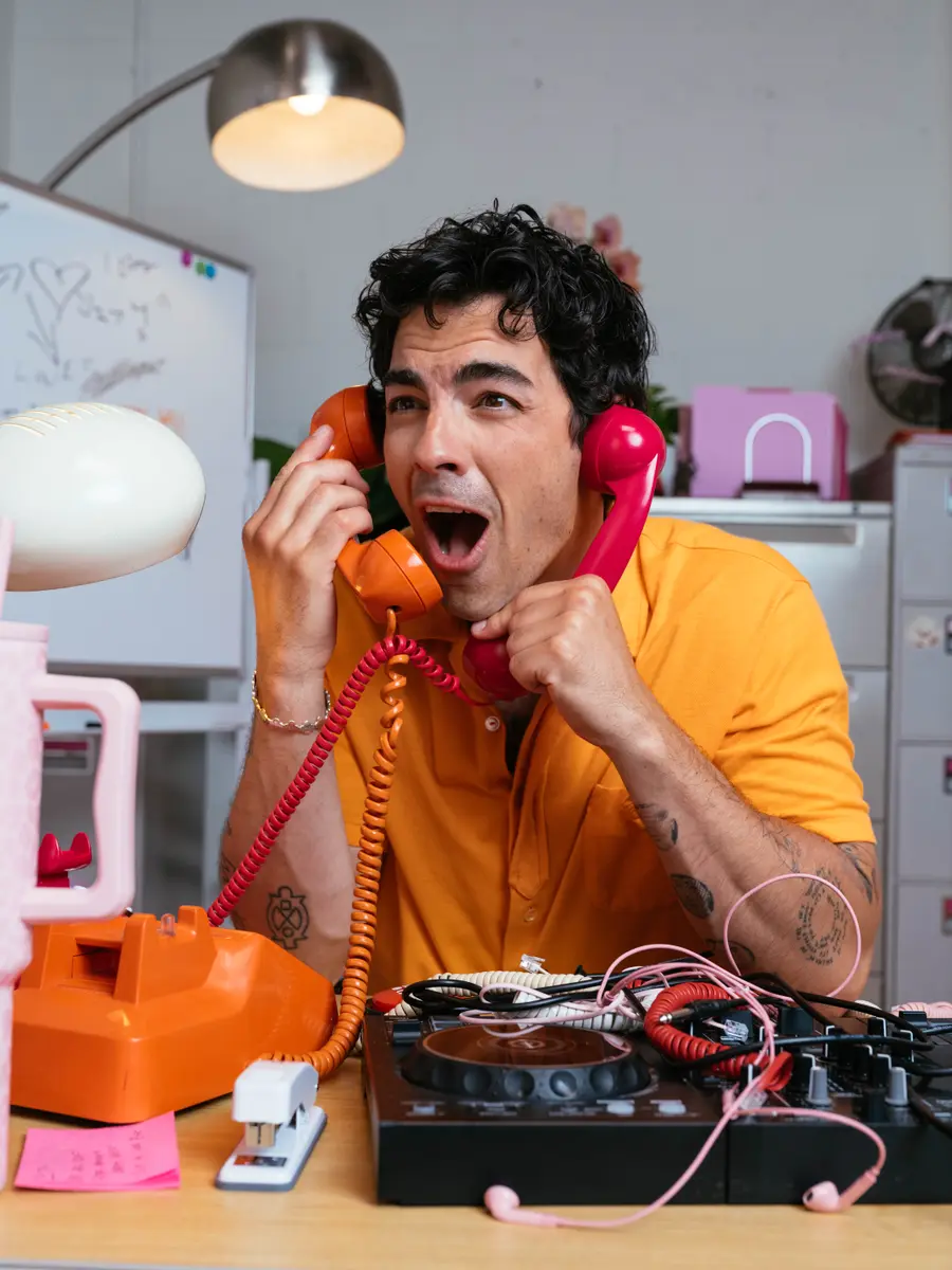 Joe Jonas on the phone for Tinder